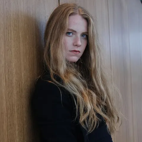 Long blonde hair styled straight